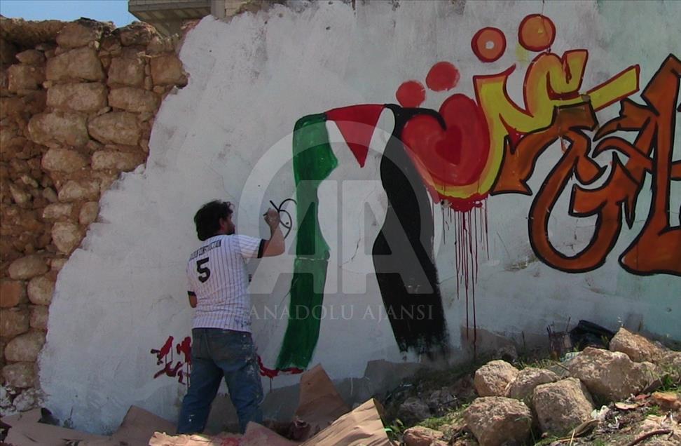 Grafitti hasil karya seniman Suriah, Aziz al Asmar