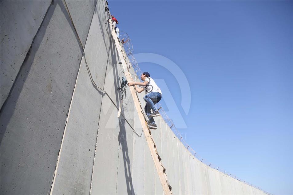 Con escaleras palestinos cruzan el muro hacia Jerusalén para hacer oración del Ramadán