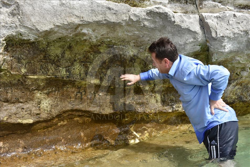 Ancient rock paintings appear after water level drops