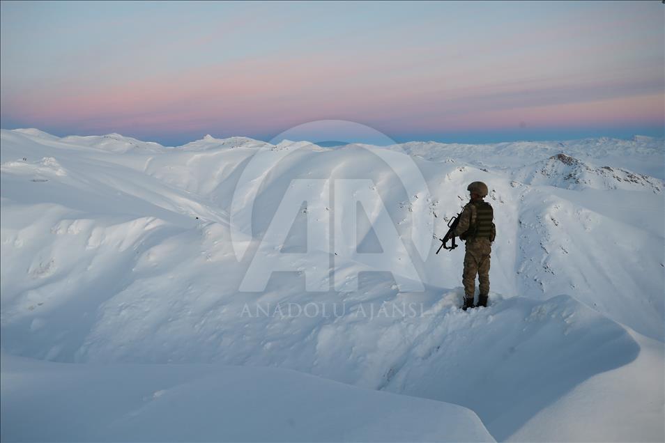 A Turkish soldier stands guard on a mountain outpost in Yüksekova region of Hakkari