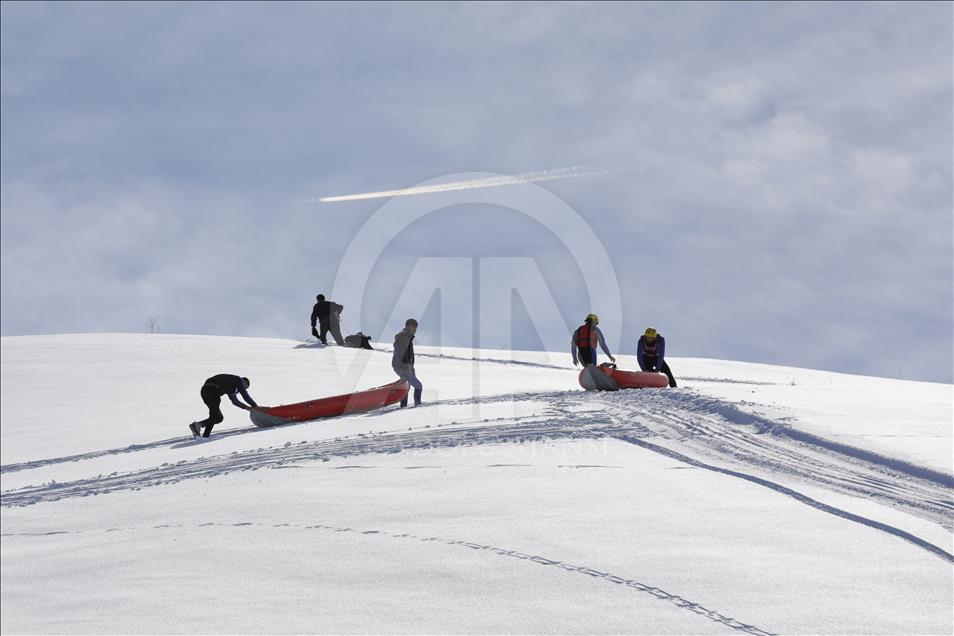 Rafting team practice on a snow covered mountain in Turkey