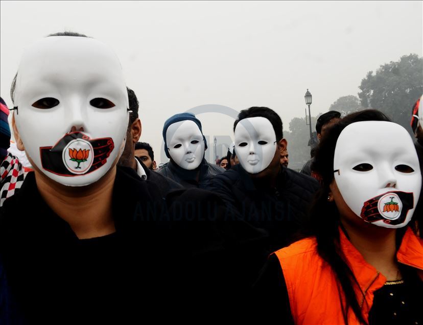 NEW DELHI, INDIA - DECEMBER 30 : Protestors hold tri-colour in front of the India Gate during a protest against the police brutality during the clashes, following days of violent protests across India against a new citizenship law, in  Delhi, India, Decem