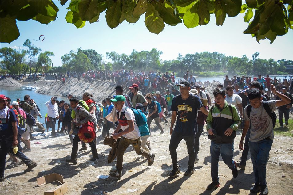 Migrants try to cross the border between Mexico and Guatemala