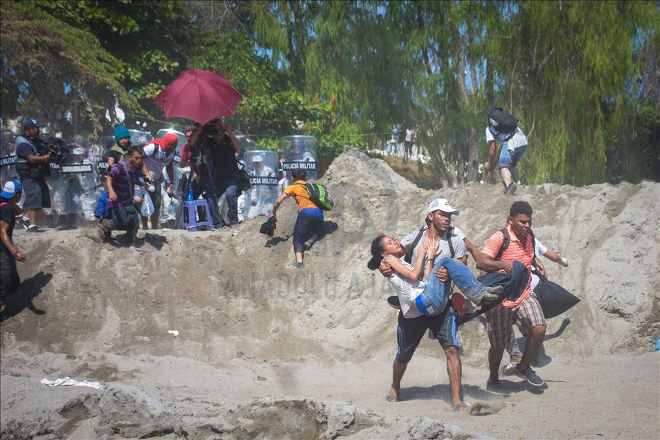 Migrants try to cross the border between Mexico and Guatemala