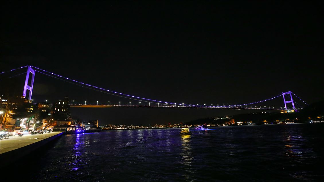 Fatih Sultan Mehmet Bridge is illuminated with purple