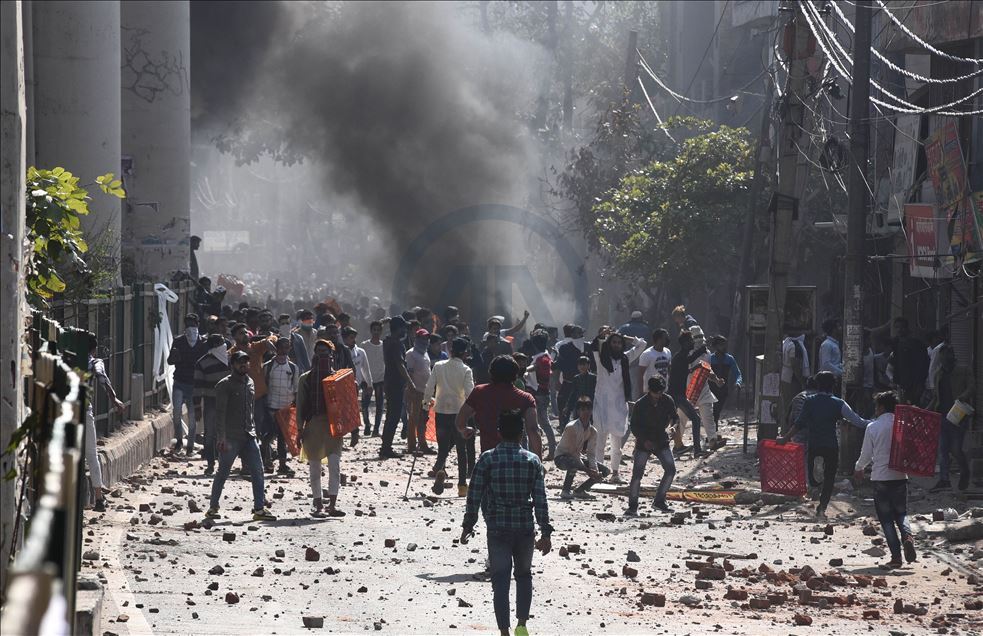 NEW DELHI, INDIA -  FEBRUARY 24 : Protestors hurl brick-bats during clashes between a group of anti-CAA protestors and supporters of the new citizenship act, at Jafrabad in Delhi Monday February 24, 2020. : Imtiyaz khan
