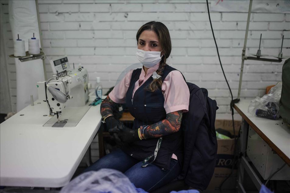 Mujeres pasan de hacer uniformes de policía a confeccionar tapabocas y trajes de bioseguridad
