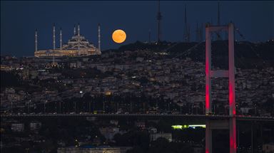 Full moon rises over Istanbul's Camlica Mosque