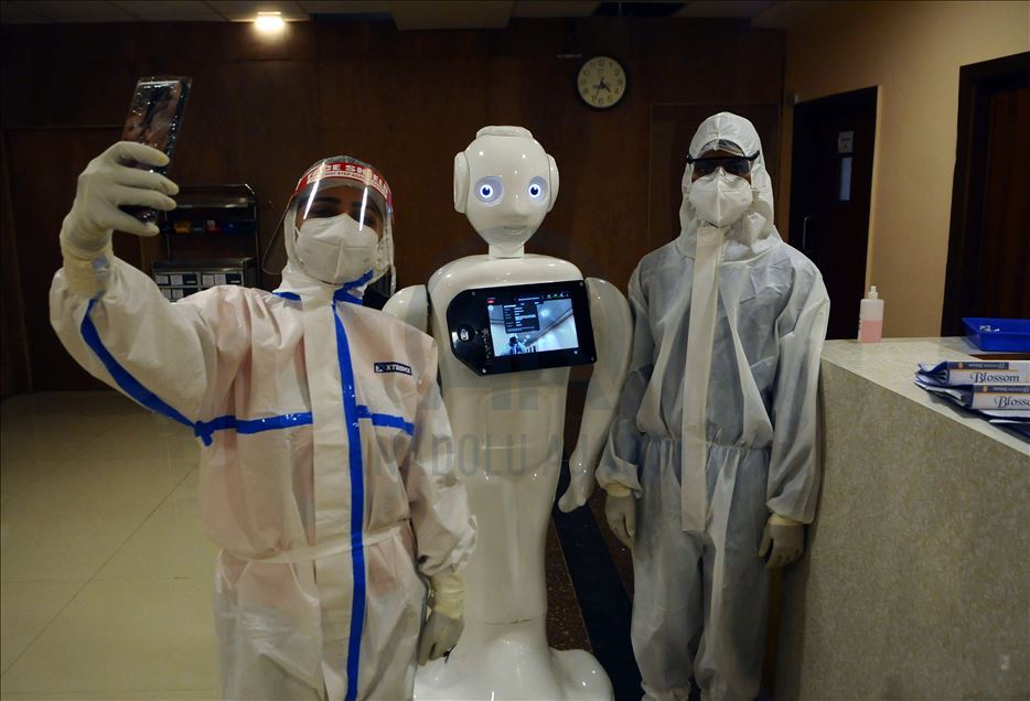 NOIDA, INDIA - SEPTEMBER 27 :Â Health workers takes selfieÂ  with Indian made Robot used for connecting Covid 19 patients with outside world and giving them a break from isolation in Covid19 ward of Yatahartha Hospital (at present treating 259 Covid 19 pa