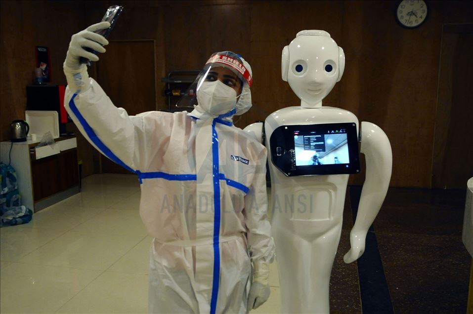 NOIDA, INDIA - SEPTEMBER 27 :Â Health workers takes selfieÂ  with Indian made Robot used for connecting Covid 19 patients with outside world and giving them a break from isolation in Covid19 ward of Yatahartha Hospital (at present treating 259 Covid 19 pa