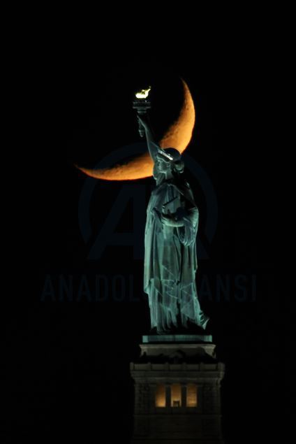Crescent Moon sets behind the Statue of Liberty in NYC