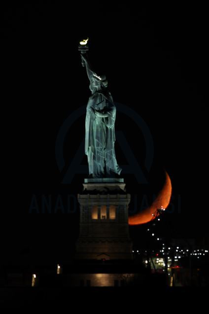 Crescent Moon sets behind the Statue of Liberty in NYC