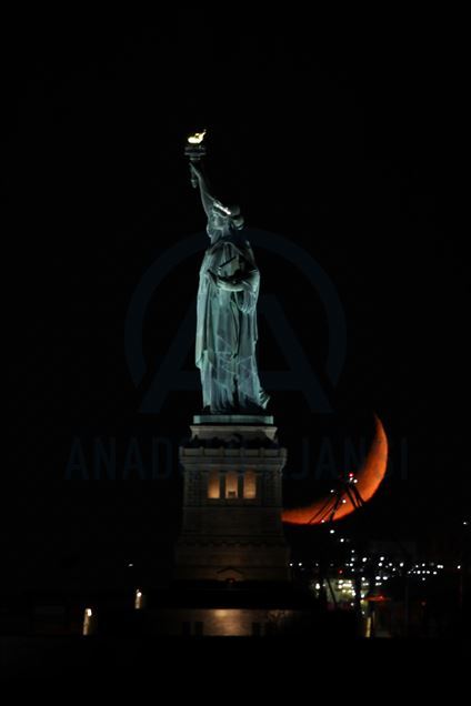 Crescent Moon sets behind the Statue of Liberty in NYC
