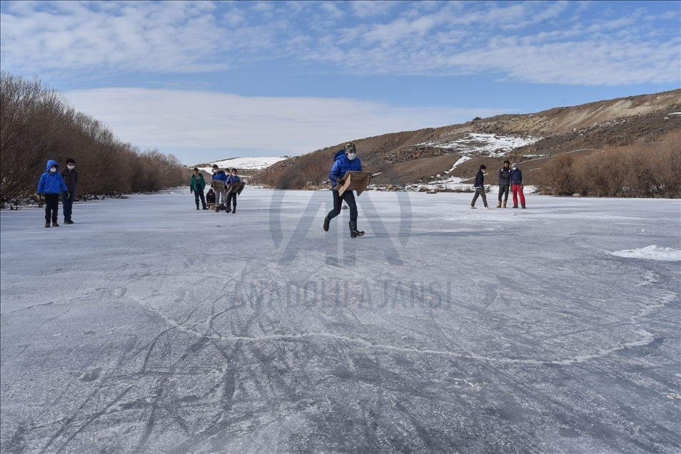 Villagers enjoy ice on the frozen Kars Stream