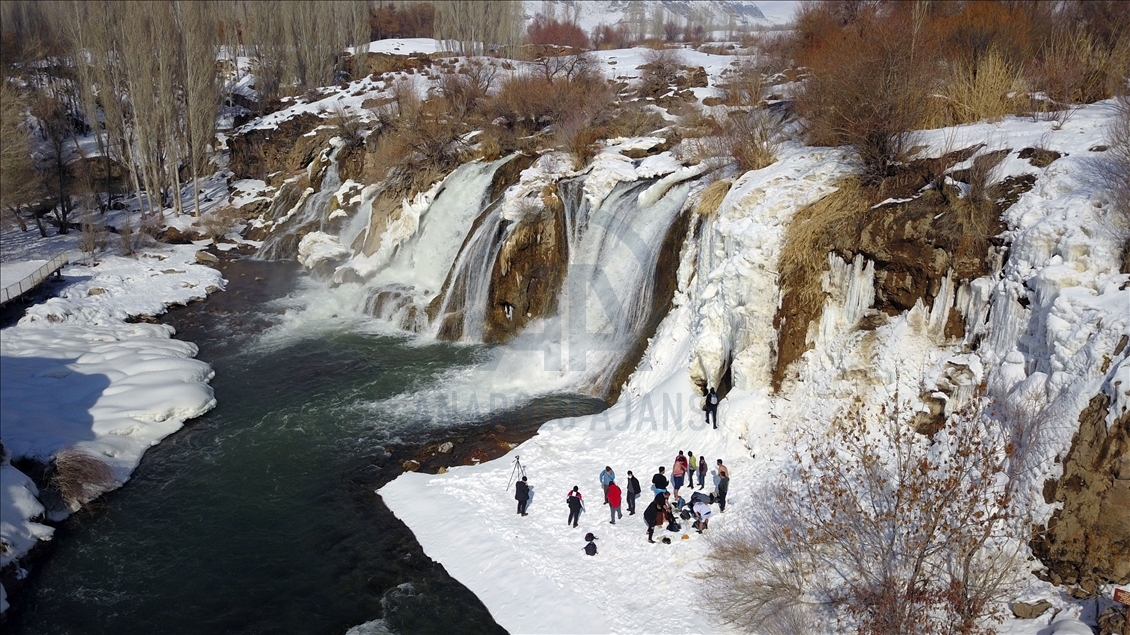 Swimming in partly frozen Muradiye Waterfall in Turkey
