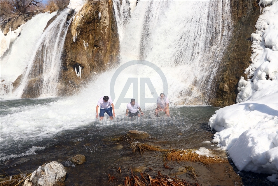 Swimming in partly frozen Muradiye Waterfall in Turkey
