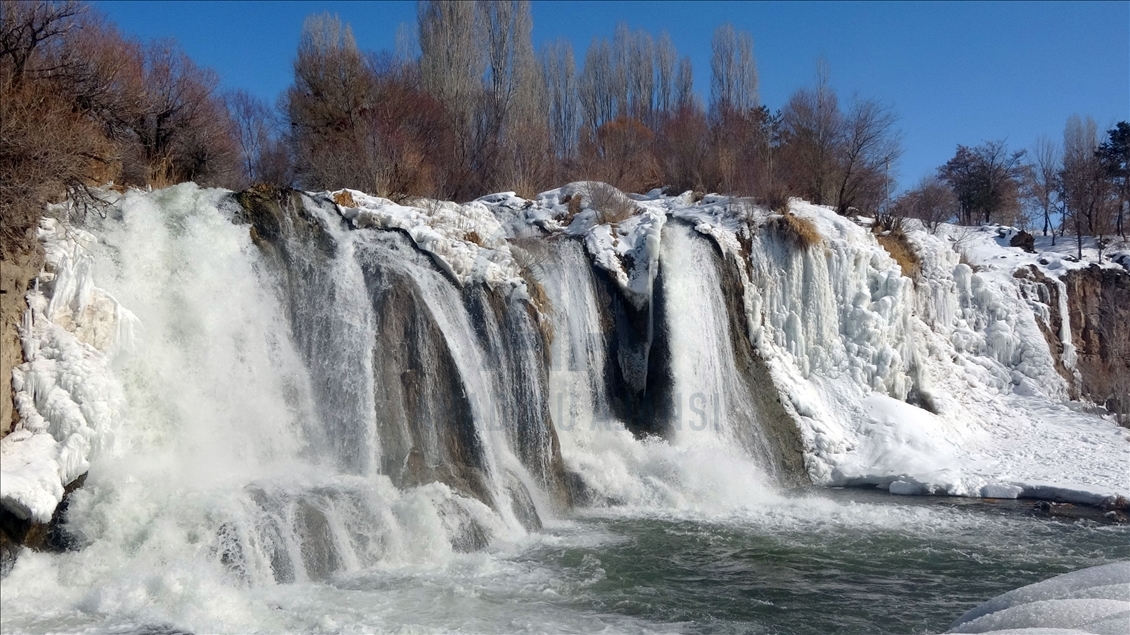 Swimming in partly frozen Muradiye Waterfall in Turkey