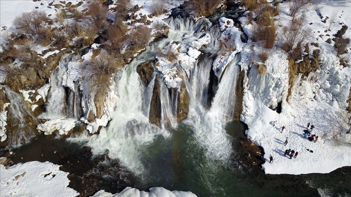 Swimming in partly frozen Muradiye Waterfall in Turkey