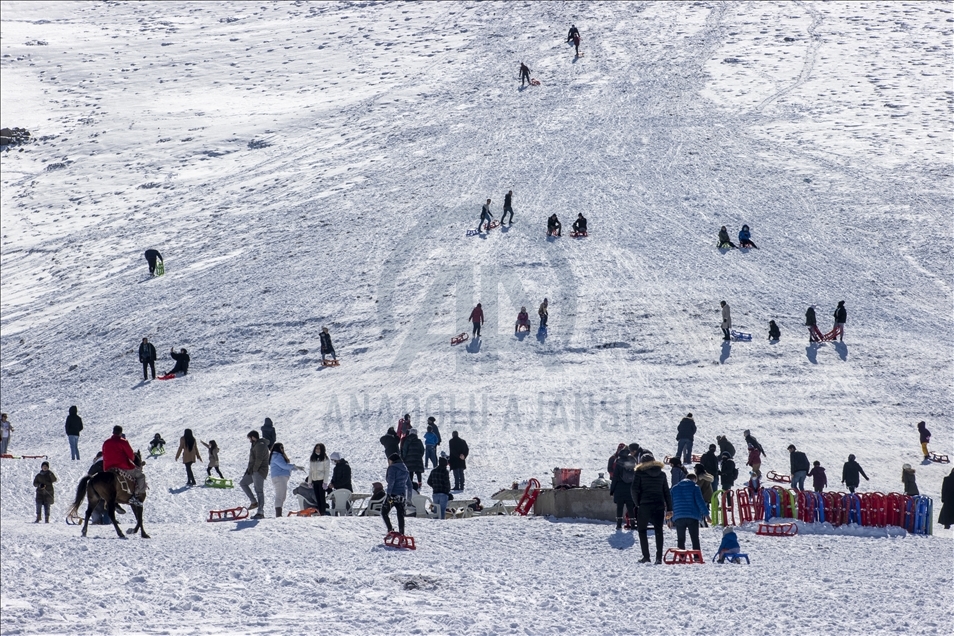 People enjoy snow at ski resort in Ankara