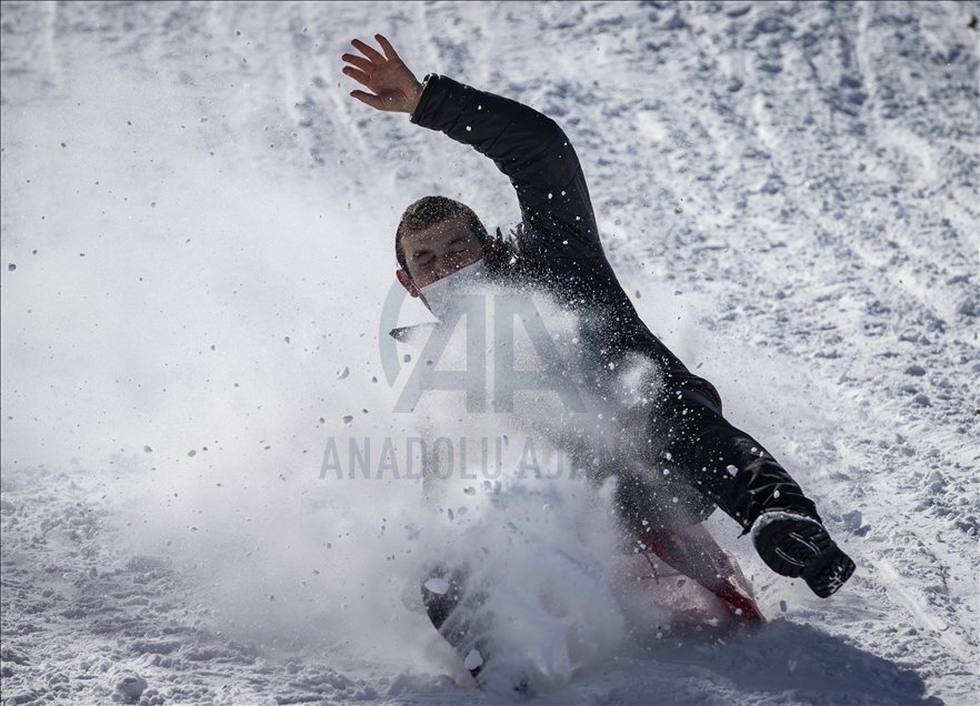 People enjoy snow at ski resort in Ankara