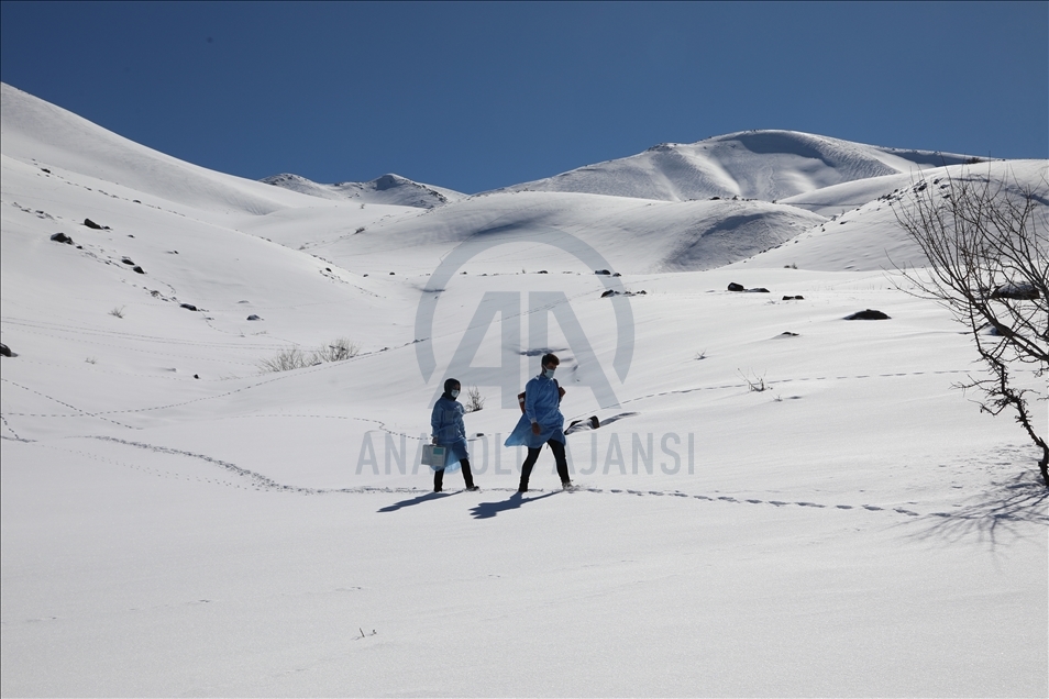 Health workers cross snowy roads, vaccinate the elderly against COVID-19 in eastern Turkey