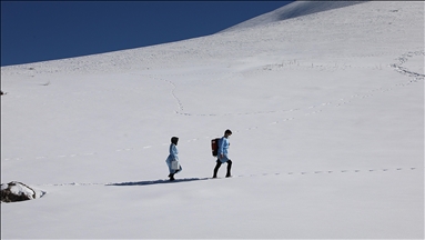 Health workers cross snowy roads, vaccinate the elderly against COVID-19 in eastern Turkey