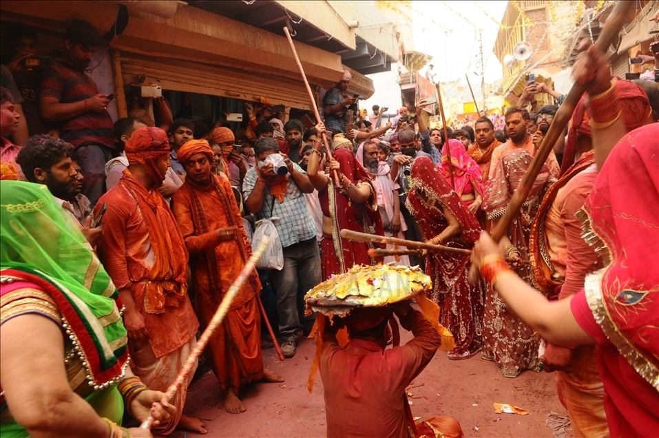 BARSANA, INDIA -MARCH 23, 2021 : Indian women beat men with sticks (lathi) during the Lathmar Holi celebration in the village of Barsana on the outskirts of Mathura in the northern Indian state of Uttar Pradesh, March on India 23,2021 : Imtiyaz Khan