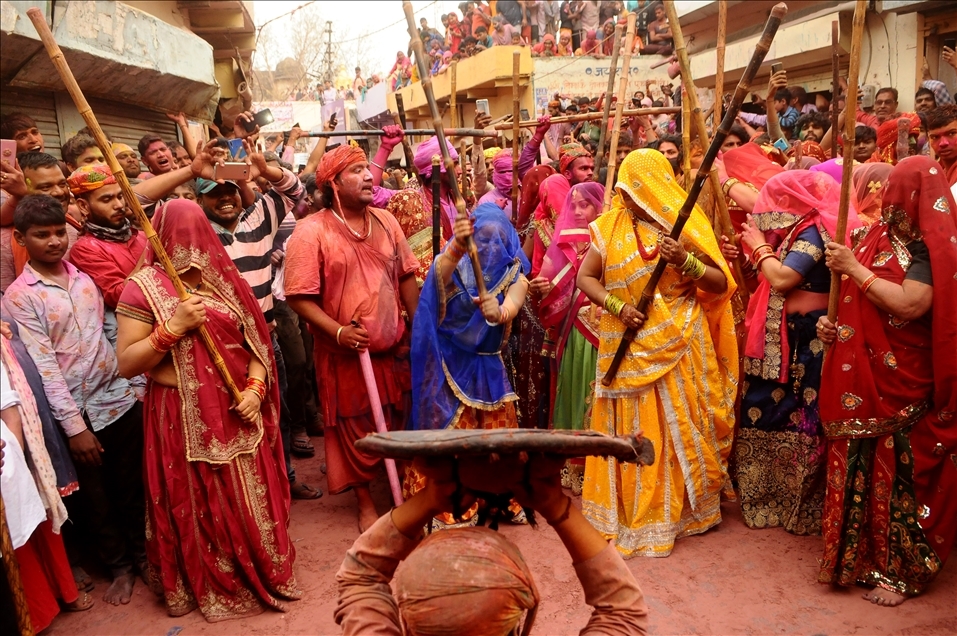 BARSANA, INDIA -MARCH 23, 2021 : Indian women beat men with sticks (lathi) during the Lathmar Holi celebration in the village of Barsana on the outskirts of Mathura in the northern Indian state of Uttar Pradesh, March on India 23,2021 : Imtiyaz Khan