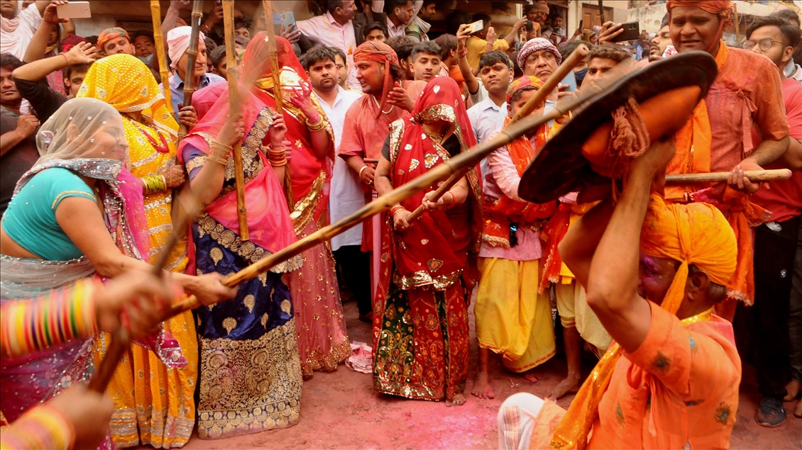 BARSANA, INDIA -MARCH 23, 2021 : Indian women beat men with sticks (lathi) during the Lathmar Holi celebration in the village of Barsana on the outskirts of Mathura in the northern Indian state of Uttar Pradesh, March on India 23,2021 : Imtiyaz Khan