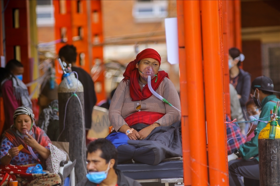 Covid-19 patients get treatment outside the passage of a hospital due to a lack of free beds in Nepal