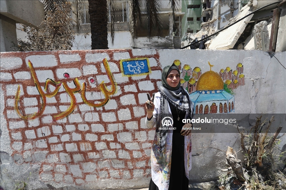 "الشيخ جرّاح" يتجسد على جدار منزل مهدوم بغزة