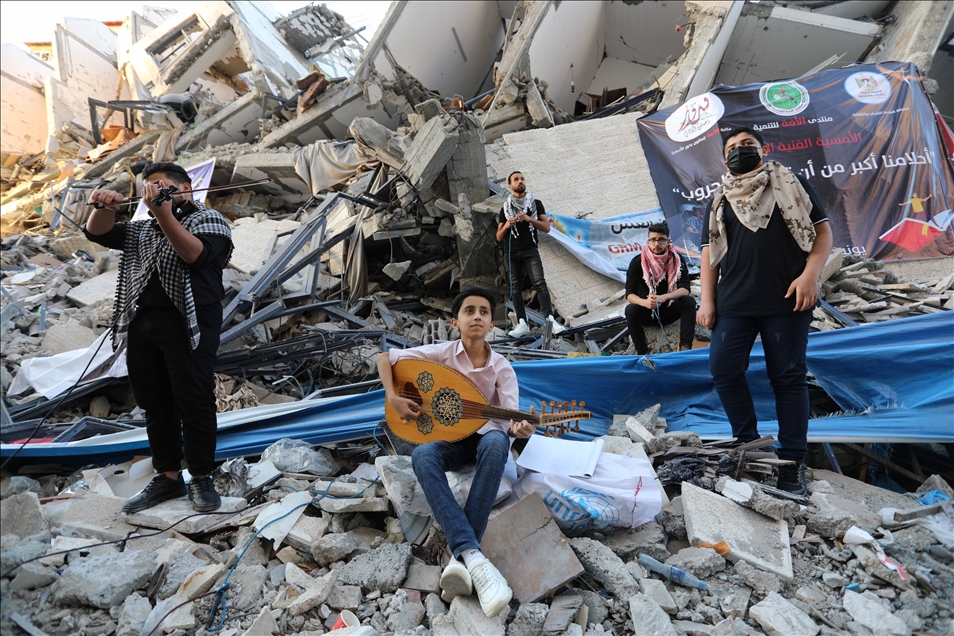 Palestinian musicians in Gaza perform concert in front of debris of buildings