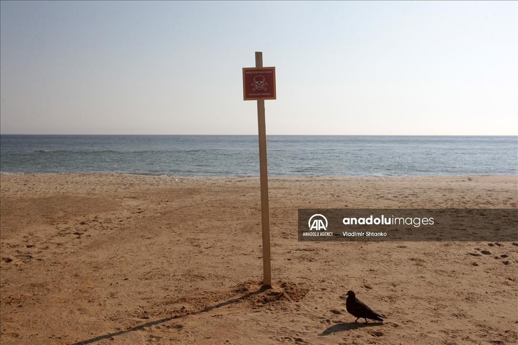 Boards saying "Dangerous mines" on a beach in Odessa