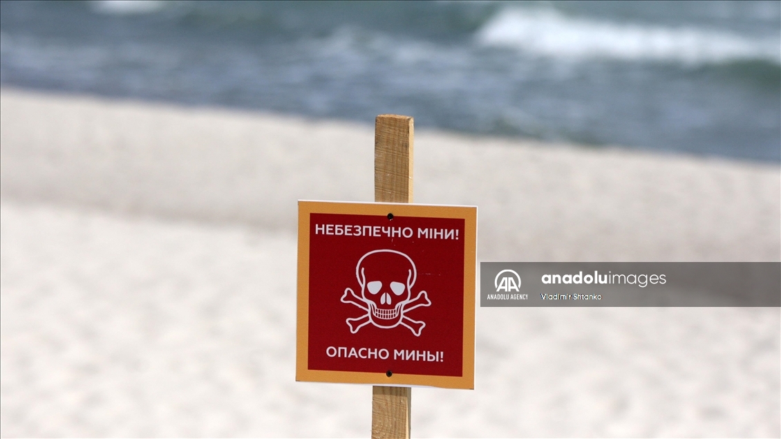 Boards saying "Dangerous mines" on a beach in Odessa