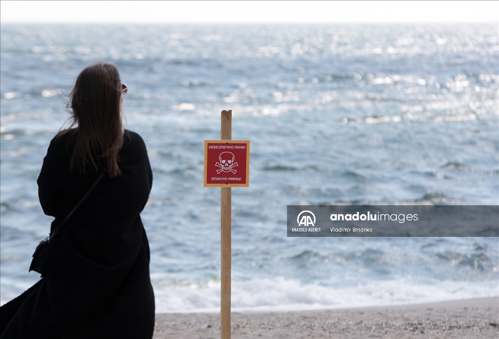 Boards saying "Dangerous mines" on a beach in Odessa