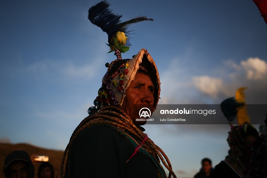 Indígena observa la puesta de sol desde una colina mientras comienza la fiesta de la cruz y Tinku en Macha, Potosí, Bolivia