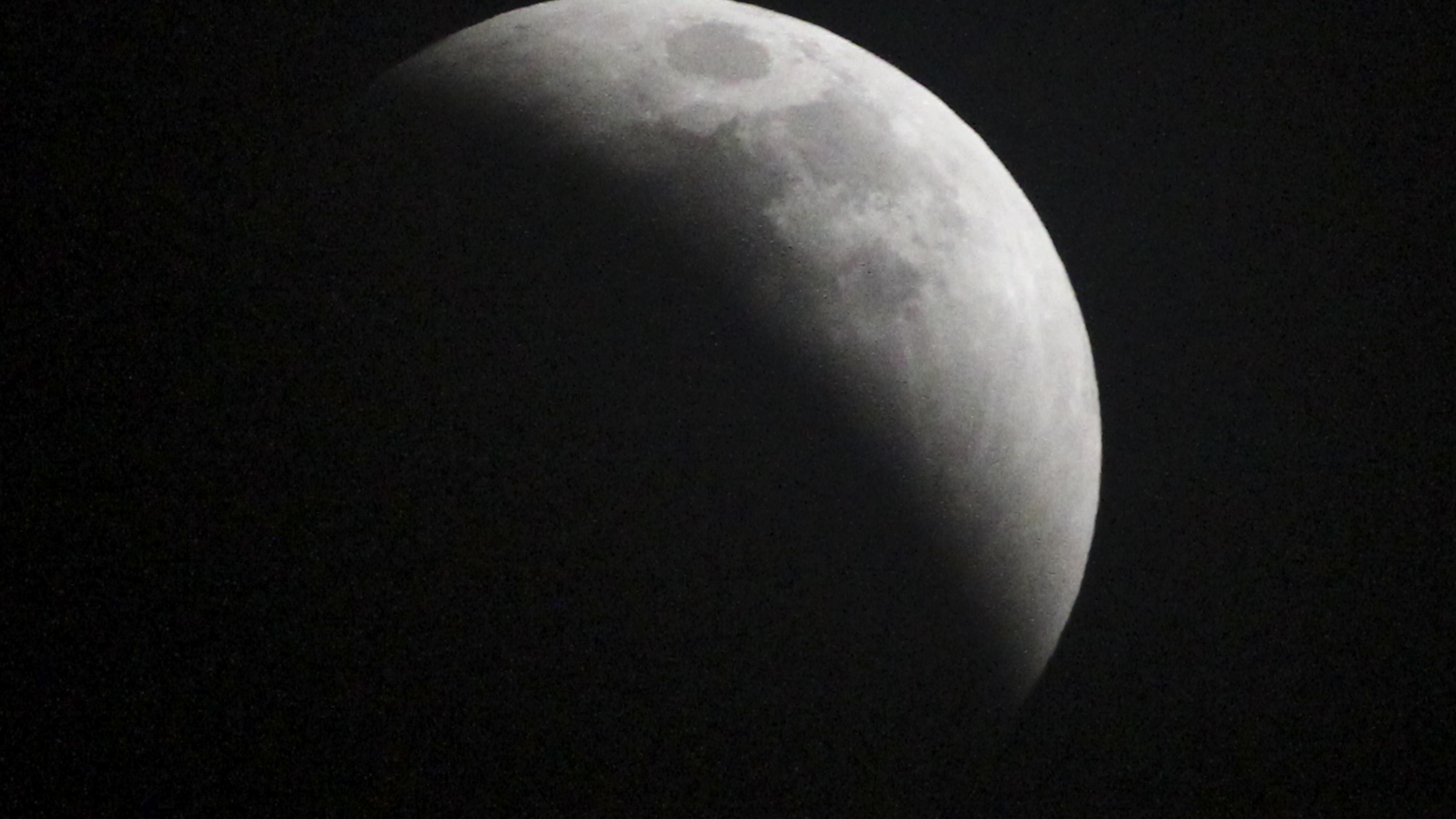 Super blood Moon emerges from gloom, as total lunar eclipse is seen around the world