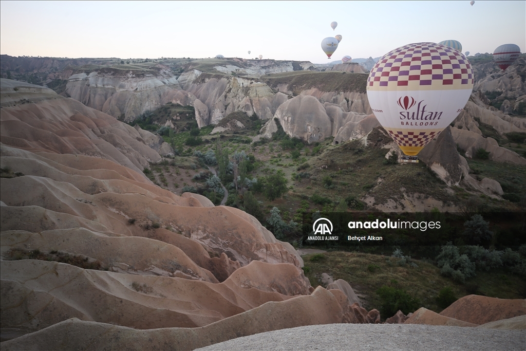 Turistler, Kapadokya'nın "renkli tepeleri"ni balondan seyrediyor