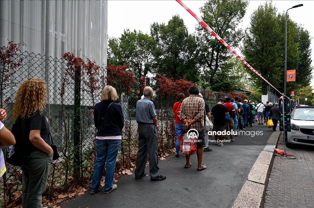 People queue for free food at non-profit association Pane Quotidiano in Milan, Italy