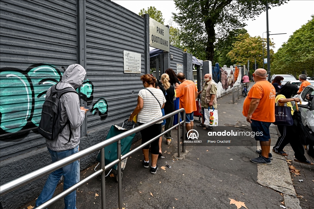 People queue for free food at non-profit association Pane Quotidiano in Milan, Italy