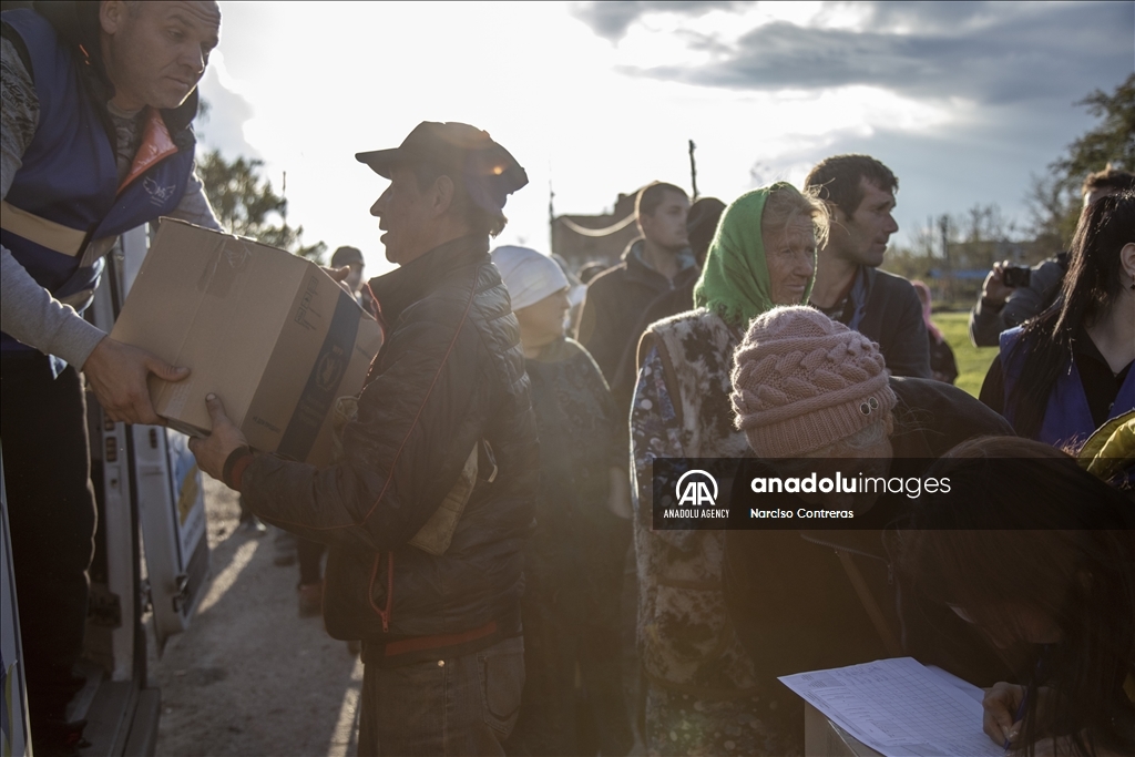 Locals receive food supplies by a humanitarian aid group in Donetsk