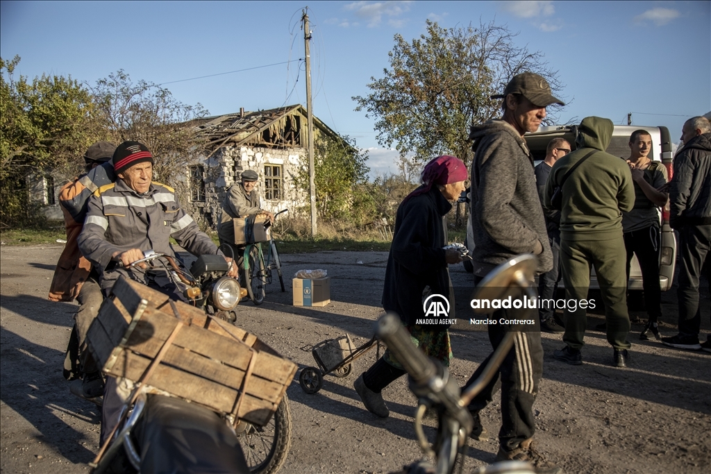Locals receive food supplies by a humanitarian aid group in Donetsk