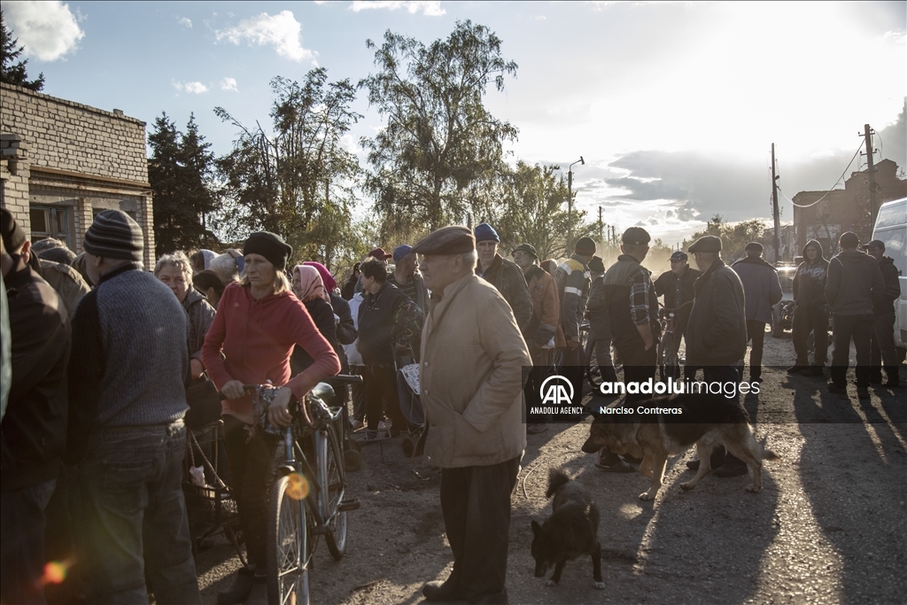 Locals receive food supplies by a humanitarian aid group in Donetsk