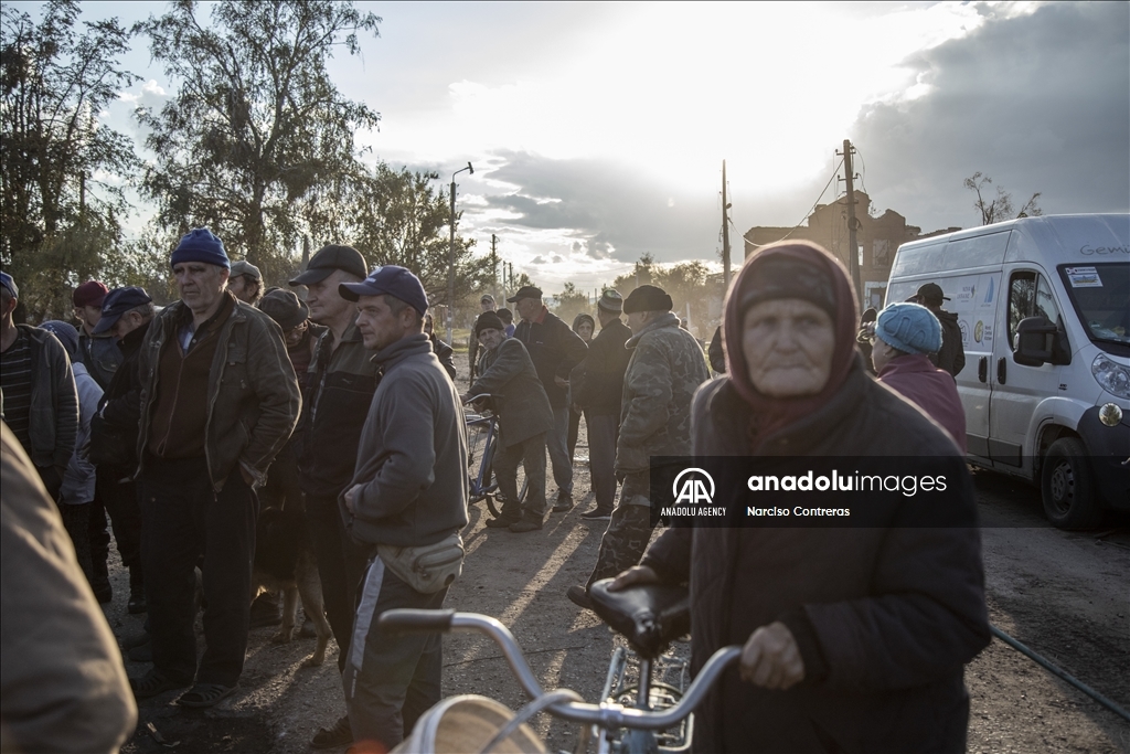 Locals receive food supplies by a humanitarian aid group in Donetsk