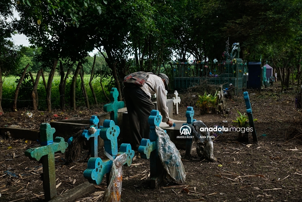 Graves in the yards of houses during dead day in El Salvador