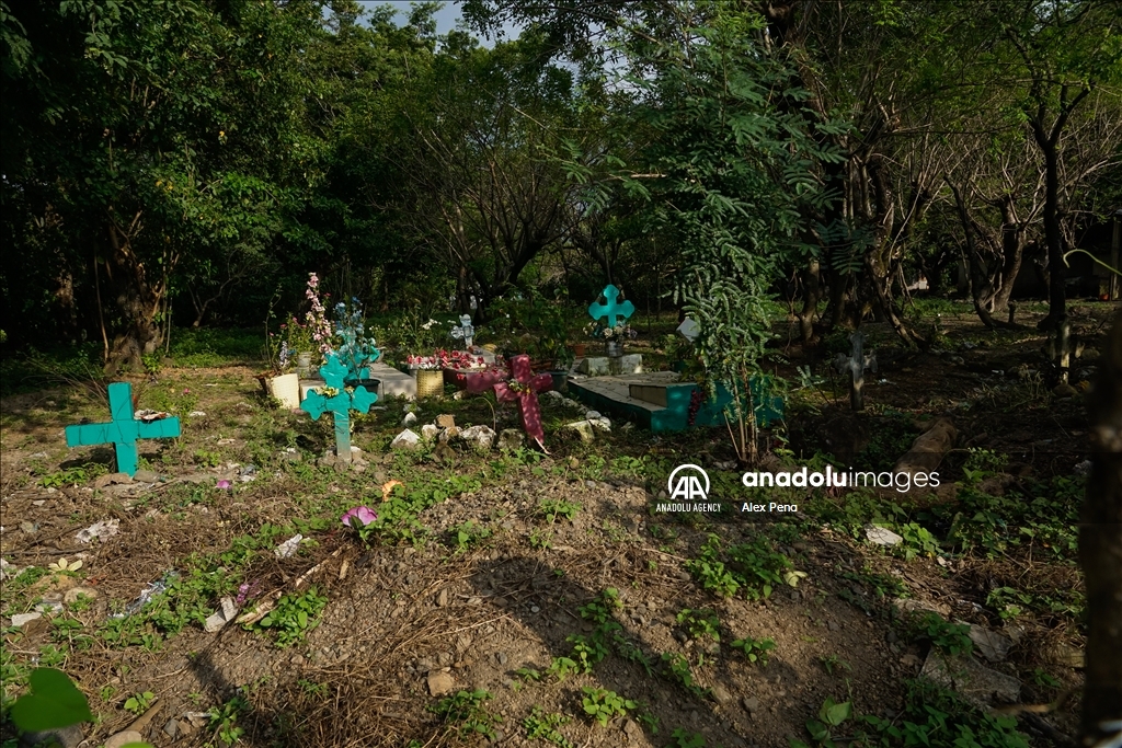 Graves in the yards of houses during dead day in El Salvador