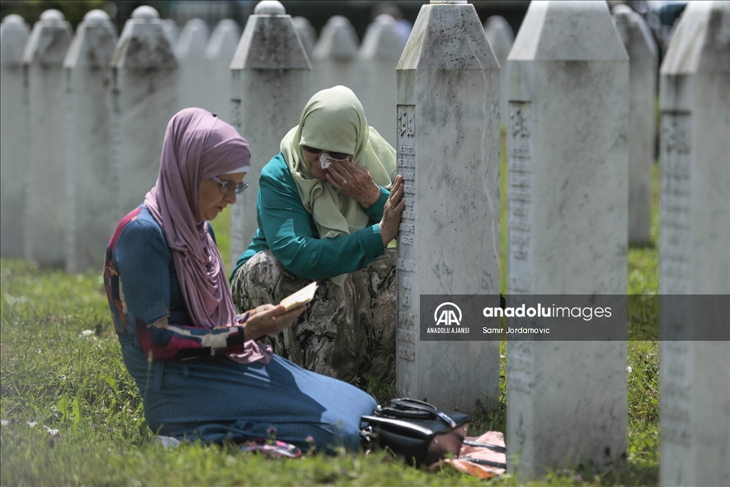 Srebrenitsalı aileler, evlatlarının mezarı başında dua ediyor