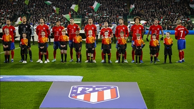 Supporters hold Palestinian flags during Celtic FC v Atletico Madrid