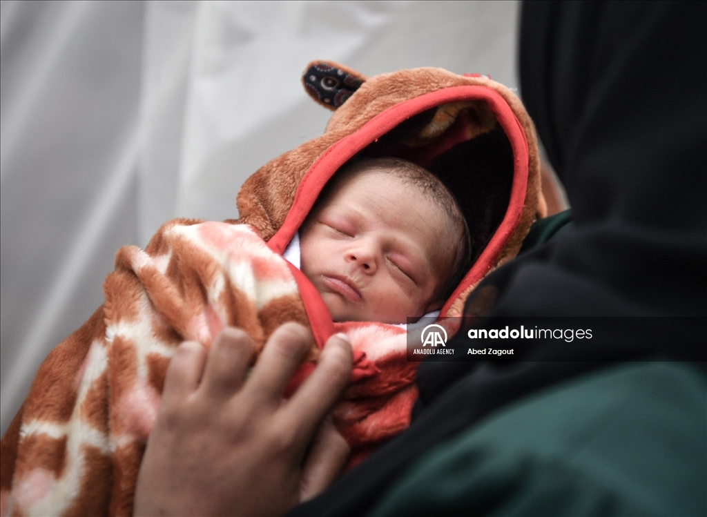 Gazan mother with her baby lives in a tent under difficult conditions in Rafah