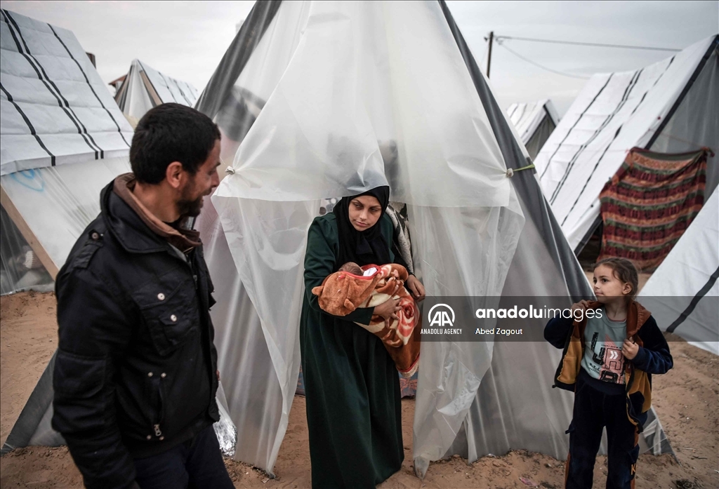 Gazan mother with her baby lives in a tent under difficult conditions in Rafah
